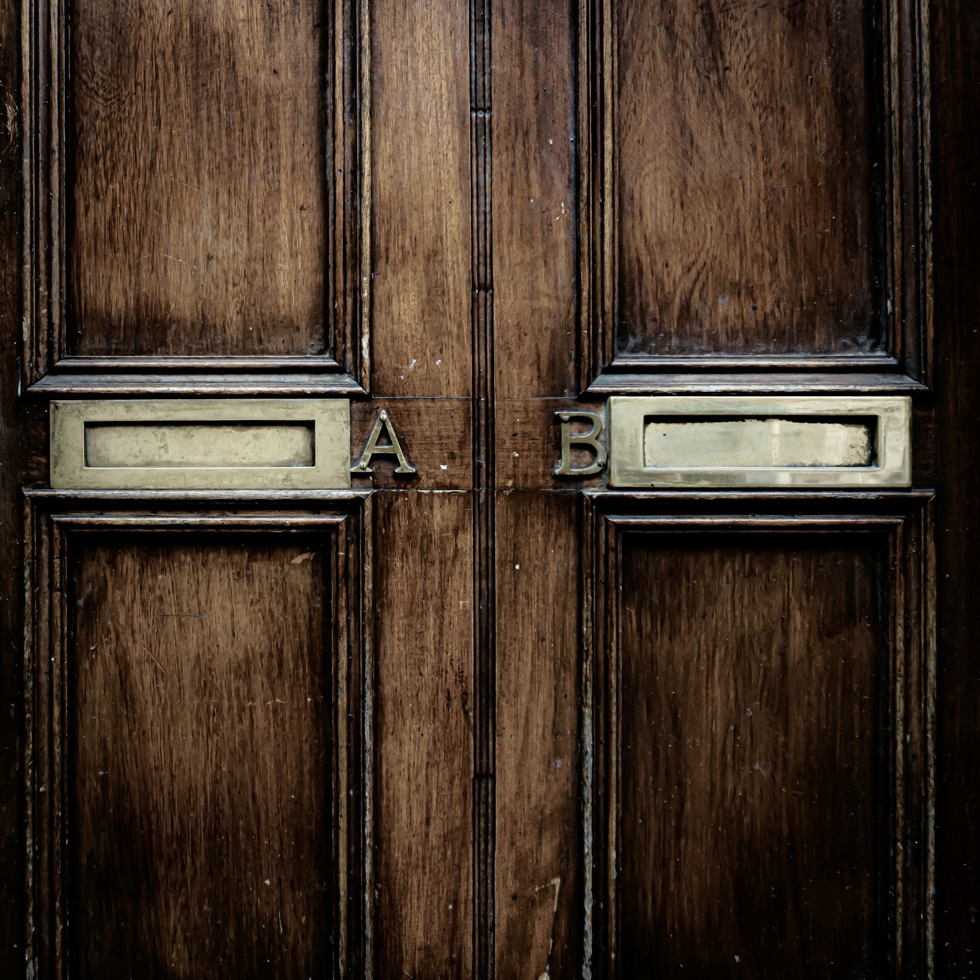 wooden-door-with-a-and-b-metal-badges